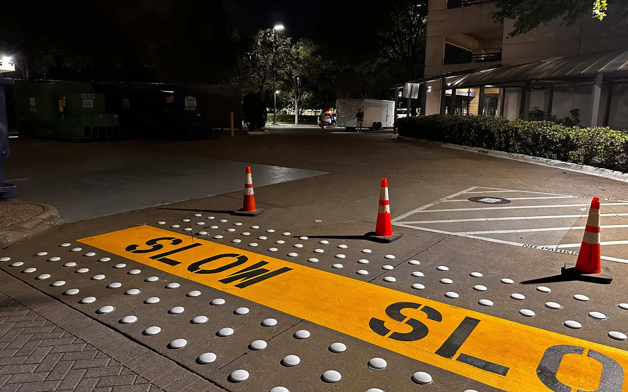 Side view of a parking lot at night with newly installed accessories